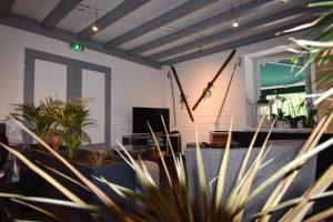 a living room with potted plants and a couch at Hôtel Le Chinfrey in Les Gets