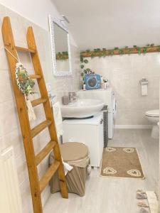 a bathroom with a ladder and a sink and a toilet at DIMORA MAJELLA in Chieti