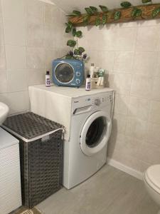 a bathroom with a washing machine and a radio at DIMORA MAJELLA in Chieti