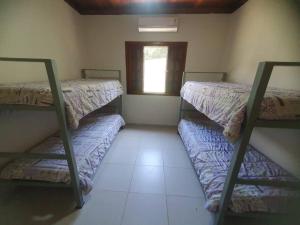 Voodi või voodid majutusasutuse Casa de Praia Barra Seca Pé na Areia toas