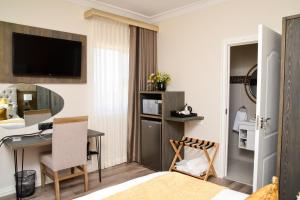 a hotel room with a desk and a bedroom at Menucha Country Lodge in Mthatha