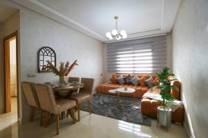 uma sala de estar com um sofá e uma mesa em Super appartement moderne Cosy em Tânger