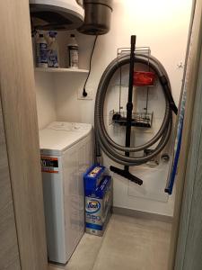 a laundry room with a washer and a hose at Villa Laura Holiday House 2 in Bologna