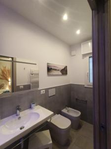 uma casa de banho com um lavatório e um WC em Villa Laura Holiday House 2 em Bolonha