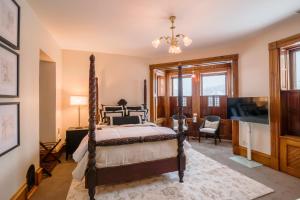 a bedroom with a bed and a flat screen tv at Squiers 1882 in Maquoketa