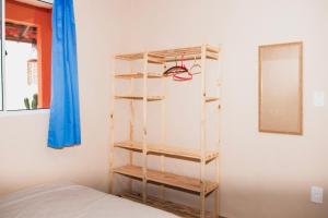 a room with a book shelf next to a bed at Casa Sol de Búzios in Búzios