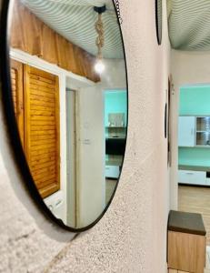a mirror on a wall in a room at Twins Apartments 2 in Ploieşti