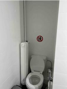 a small bathroom with a toilet and a no smoking sign at JR apartments in Athens