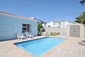 a swimming pool in the backyard of a house at Family Tides in Yzerfontein