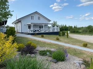 a white house with a porch and a garden at Vila Bianca in Inturkė