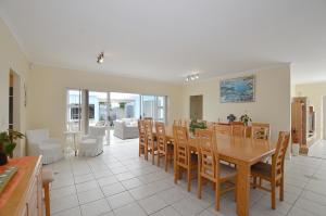 a kitchen and dining room with a table and chairs at Family Tides in Yzerfontein