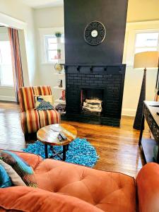 a living room with a couch and a fireplace at Charming! near CLE Clinic/UH/CWRU/Dwntwn w/porch in Cleveland