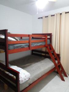 two bunk beds in a room with a curtain at Caleta in La Romana