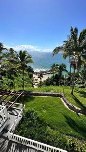 a view of the ocean from a balcony of a resort at Vista Mare Ocean View Top Floor Condo, Samana in Santa Bárbara de Samaná