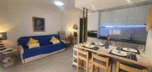 un soggiorno con divano blu e una cucina di Monte Gordo T1 Parque dos Reis a Monte Gordo