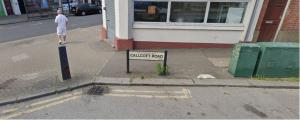 a sign on a street in front of a building at Callcote road Hotel in London