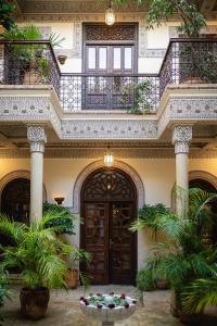 ein Gebäude mit einem Balkon mit Pflanzen im Innenhof in der Unterkunft La Villa des Orangers - Relais & Châteaux in Marrakesch