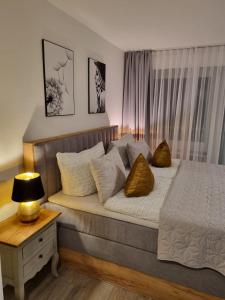 a bedroom with a bed and a table with a lamp at PANORAMA INN - nahe Messe contaktless check-in in Hannover