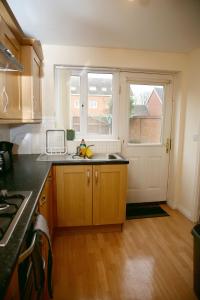 an empty kitchen with a sink and a window at Stylish beautiful Lodge in Norwich in Norwich