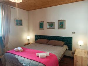 a bedroom with a bed with two towels on it at Matese Home in San Massimo