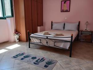 a bed in a room with two mats on the floor at Agistri SOPHIA'S APARTMENT in Skala
