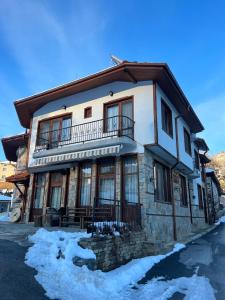 a large stone house with a balcony on top at Hotel Daffi in Smolyan