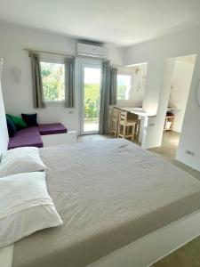Lagoon Apartment في دهب: غرفة نوم بيضاء مع سرير كبير ومكتب