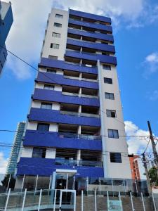 a tall building with blue panels on it at Apartamento na praia de Manaira in João Pessoa
