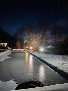 an icy street at night with lights on at Chata Ignasia pod Śnieżnikiem 1 na działce in Stronie Śląskie