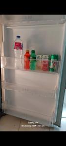 an open refrigerator filled with bottles of water and juice at تراس سموحه - بيتك يطل علي نادي سموحه in Alexandria
