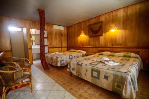 Uma cama ou camas num quarto em Hotel Manavai