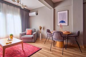 a living room with a table and a chair at TAKS-INN Hotel in Istanbul