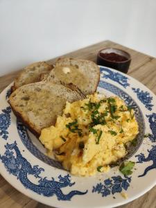a plate of food with eggs and bread on a table at The Larch Room in Brandsby