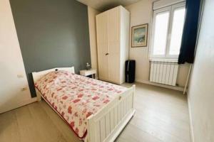a bedroom with a bed and a window at Villa l'écluse in Le Tréport