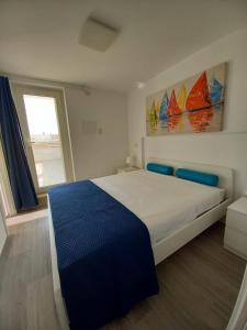 a bedroom with a large bed and a window at Aura Apartments - Orizzonte Turismo in Porto Cesareo