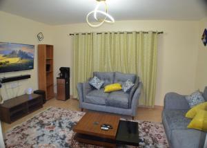 a living room with a couch and a coffee table at Bright Box 1 br near JKIA in Nairobi