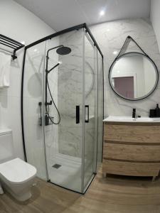 a bathroom with a shower and a toilet and a mirror at Casa Alma in Montoro +10 photos