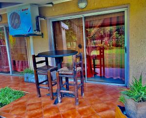 a table and two chairs on a patio at Five Stars Lodge in Phalaborwa