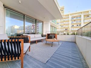 a balcony with chairs and a table on a building at Bayline Condominium - Heated indoor Swimming pool - SPA - By Bedzy in Armação de Pêra