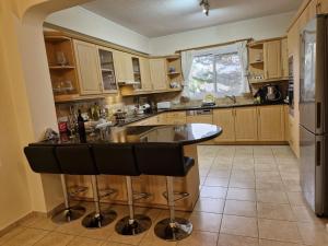 a kitchen with a island in the middle of it at Givon Palace in Paphos