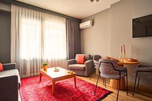 a living room with a couch and chairs and a table at TAKS-INN Hotel in Istanbul