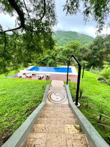 a brick path leading to a swimming pool at Casa Quincho ROMA in Salta