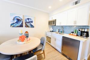 a kitchen with a table and a small table and chairs at Luxury Villa - Flora View - Ground Level -Seascape in Aptos