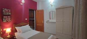 a red bedroom with a bed and a red wall at Volcán de Sal in Mazo +25 photos
