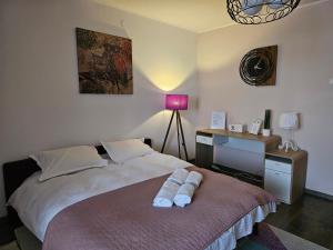 a bedroom with a bed with a desk and a lamp at Stone Bridge Studio in Iaşi