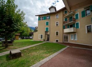 a large building with a grassy yard in front of it at appartement proche lac d'Annecy in Faverges