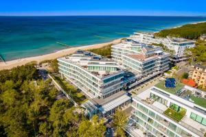 an aerial view of a building next to the beach at Mielno Dune B Apartamenty in Mielno