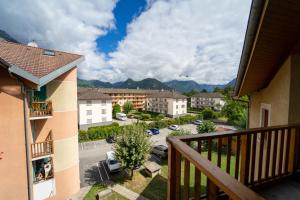 a balcony with a view of a city and mountains at appartement proche lac d'Annecy in Faverges