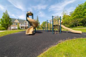 a playground with two slides in a park at Horseshoe Valley Suites - The Maple in Shanty Bay