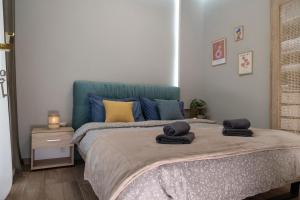 a bedroom with a bed with towels on it at Evaggelia's Apartment 6 Small Diamont in Kozani